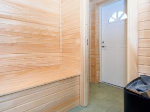 a sauna with wooden walls and a door at 7 person holiday home in Grenaa in Grenå