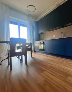 a living room with a table and a kitchen at Jade Valbrona Apartment in Valbrona +13 photos