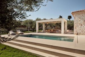 a swimming pool in a backyard with a gazebo at Conte Maris VI in Tragaki