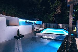 una piscina in un cortile di notte di Modern Mountain Villa House with Private Pool, Jacuzzi & Sauna - Sarajevo Trebevic a Sarajevo