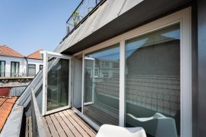 a balcony with sliding glass doors on a house at Galerias Nightlife Fashion Flats in Porto