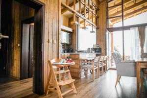 a kitchen and dining room with a table and chairs at Pirin Golf Villa Relax in Razlog