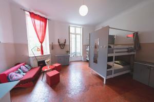 a living room with a couch and a bunk bed at La Maïoun Guesthouse in Nice