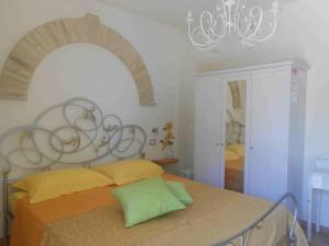 a bedroom with a bed and a chandelier at A Casa Di Pici in Porto Potenza Picena