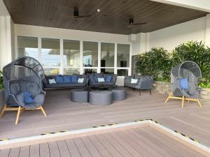 two chairs and a couch on a patio at Kozzy Loft Sitari Condominium in Bacolod
