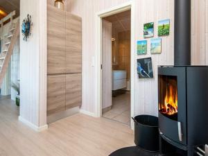 a living room with a fireplace and a staircase at 5 star holiday home in Ansager in Ansager
