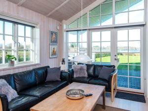a living room with a couch and a table at 5 star holiday home in Ansager in Ansager