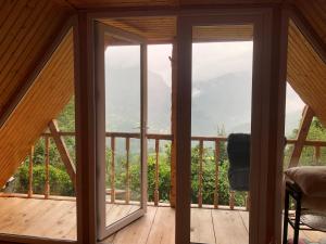 a room with a balcony with glass doors at Anna villa in Tsʼkhemlisi +7 photos