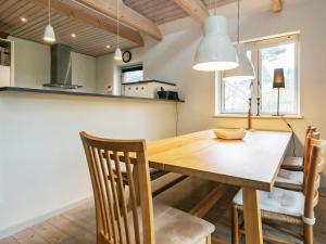 a kitchen and dining room with a wooden table and chairs at 5 person holiday home in Millinge in Millinge