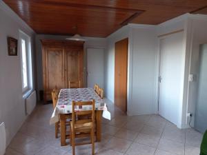 a dining room with a table and some chairs at Gîte des Galvachers in Alligny-en-Morvan