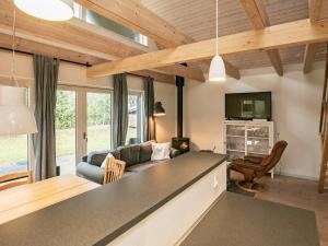 a living room with a couch and a tv at 5 person holiday home in Millinge in Millinge