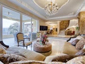 a living room with a couch and a chandelier at Luxury Home Villa Pallazzo in Lovran