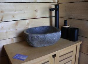a stone sink sitting on top of a counter at Les Cabanes du Moulin de l'Ortille & SPA in Compiègne