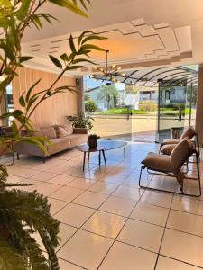 a lobby with couches and a table in a building at Hotel Boa Viagem in Barra do Garças