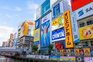a group of buildings with signs in a city at TasoneUrbanStayOsaka 梅田北EFB2F in Wada