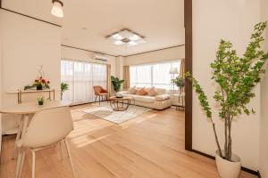 a living room with a couch and a table at Mori hotel 十条401 in Tokyo +72 photos