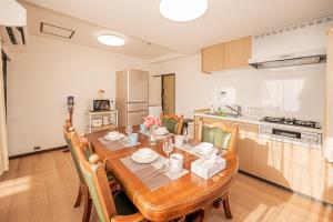 a kitchen and dining room with a wooden table and chairs at Mori hotel 十条401 in Tokyo