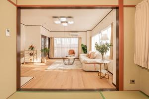 a living room with a couch and a table at Mori hotel 十条401 in Tokyo
