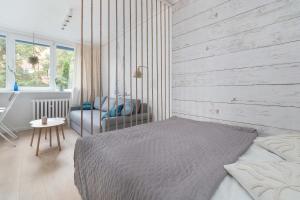 a bedroom with a swing bed and a chair at Baltic Studio 15 minutes from the Beach by Noclegi Renters in Gdańsk