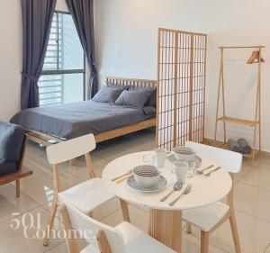 a room with a table and chairs and a bed at Cyberjaya - Netflix - Disney - Wifi in Cyberjaya