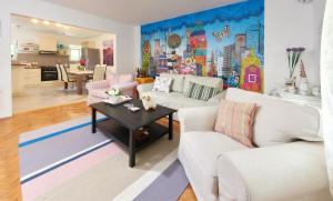 a living room with two couches and a table at Gardelin Apartment in Tivat