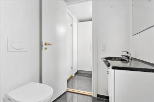 a bathroom with a toilet and a sink at LD Central Lejlighed Odense C in Odense