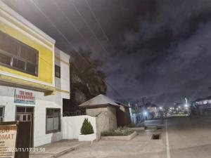 a city street at night with a building at 2 bedroom Apartment - East legon in Accra