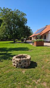 a stack of bricks in a yard with a tree at VárLak in Várbalog