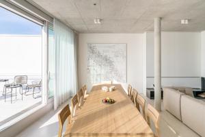 a dining room with a wooden table and chairs at Carlotta Apartments in Berlin
