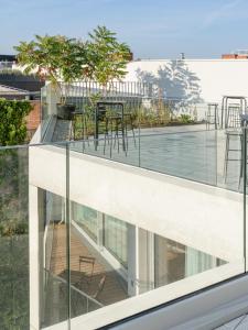 a balcony with a table and chairs on a building at Carlotta Apartments in Berlin