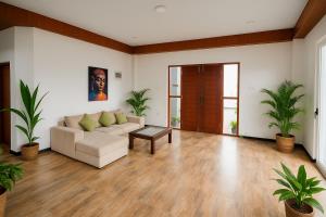 a living room with a couch and some plants at Goalie Beachfront Resort in Hikkaduwa