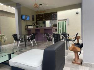 a living room with a glass table and chairs at Hotel LA RESIDENCE in Sèmè