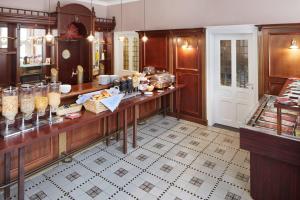 a kitchen with a counter with food on it at Hotel Hoeker Hof in Greven