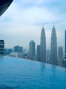 a infinity pool with a view of the city at Eaton Residences By Classic in Kuala Lumpur