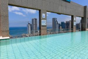 a swimming pool on the roof of a building at Gefinor Rotana – Beirut in Beirut