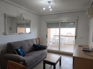 a living room with a couch and a table at ACV - Torremar-2ª linea planta 8 norte in El Borseral