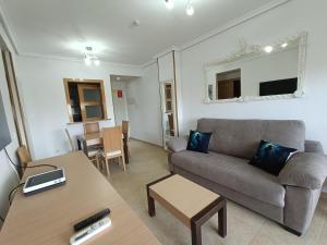 a living room with a couch and a table at ACV - Torremar-2ª linea planta 8 norte in El Borseral
