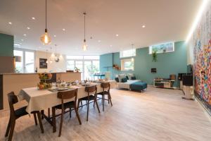 a dining room and living room with a table and chairs at Magazzini Sasso Guest House in Bussoleno