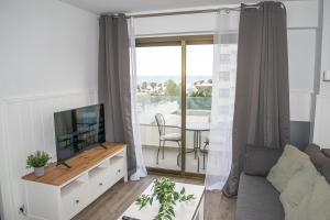 ein Wohnzimmer mit Sofa und Fernseher in der Unterkunft Ocean House Apartamento Exclusivo Vista Mar B 1 Plta 4 by Costa del Sol Stay in Torremolinos