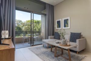 a living room with a couch and a table at Zimbali Suites 617 in Ballito