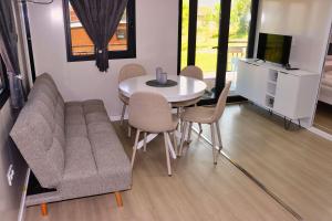 a living room with a couch and a table and chairs at Rama holiday resort in Prozor