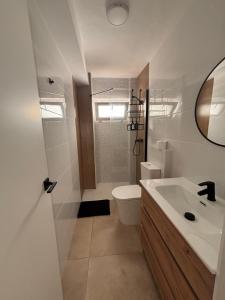 a bathroom with a toilet and a sink at Apartamentos RoMar Campillos in Campillos +20 photos