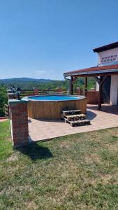 a patio with a swimming pool and a gazebo at Kuća za odmor Tihi raj 