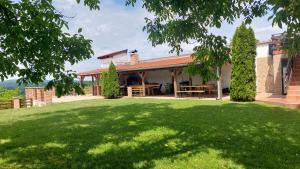 a house with a large lawn in front of it at Kuća za odmor Tihi raj 
