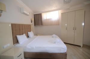 Postel nebo postele na pokoji v ubytování Funda Hotel