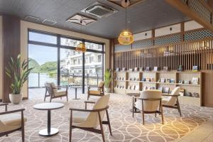 a library with chairs and tables and a book shelf at TAOYA Nachikatsuura in Nachikatsuura