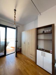a living room with a large sliding glass door at BLUE HOUSE in Paliouri