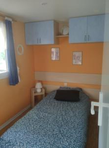 a bedroom with a bed and cabinets and a window at Bleu d'Argonne in Le Chesne +8 photos