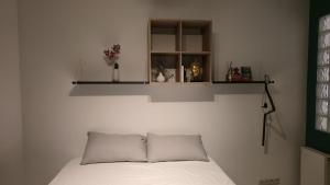 a bed with two pillows and a shelf above it at Royal sleeping Brussels in Brussels