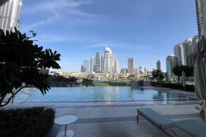 a large swimming pool with a city in the background at Burj Khalifa View Apartment in Dubai